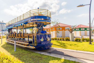 blue trolley in front of Aruba's cruise terminal
